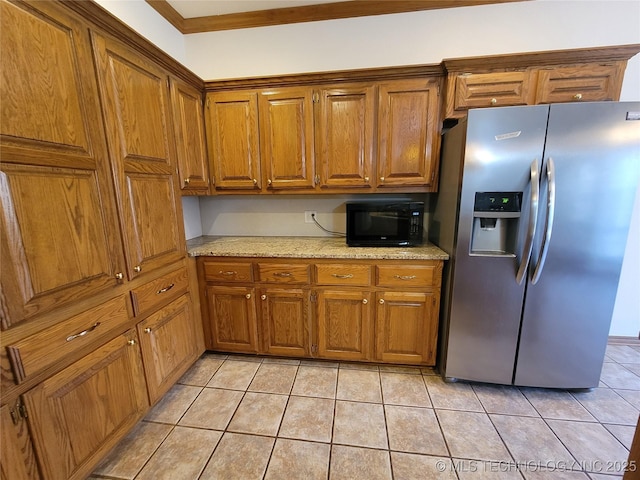 46 Acorn St, Eufaula, OK 74432 - kitchen with stainless steel fridge with ice dispenser, black microwave, brown cabinetry, light tile patterned floors, and light stone countertops