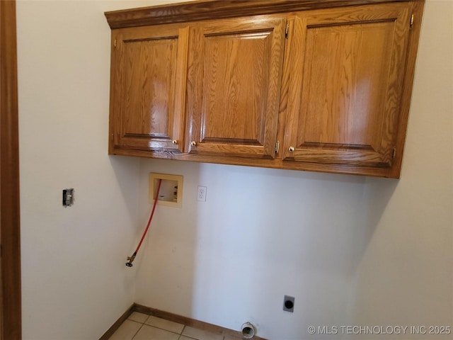 46 Acorn St, Eufaula, OK 74432 - laundry room with cabinet space, washer hookup, electric dryer hookup, and light tile patterned floors