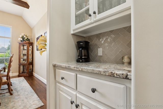 8906 E 110th St, Tulsa, OK 74133 - bar featuring backsplash, dark wood-type flooring, baseboards, and lofted ceiling