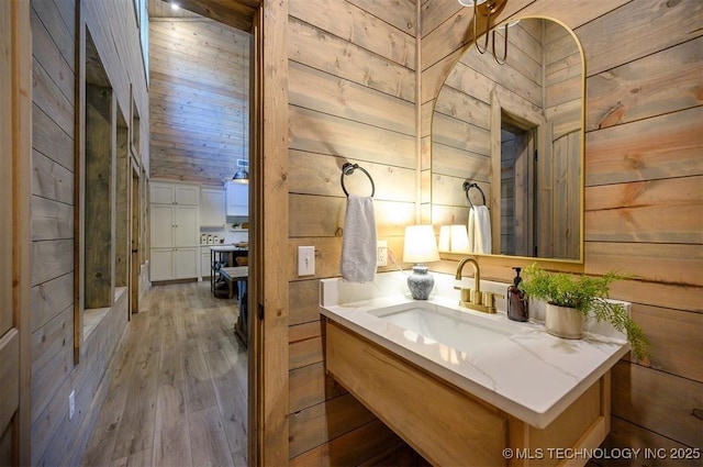 475 Bear Pine Trl, Broken Bow, OK 74728 - bathroom with wooden walls, wood finished floors, and vanity