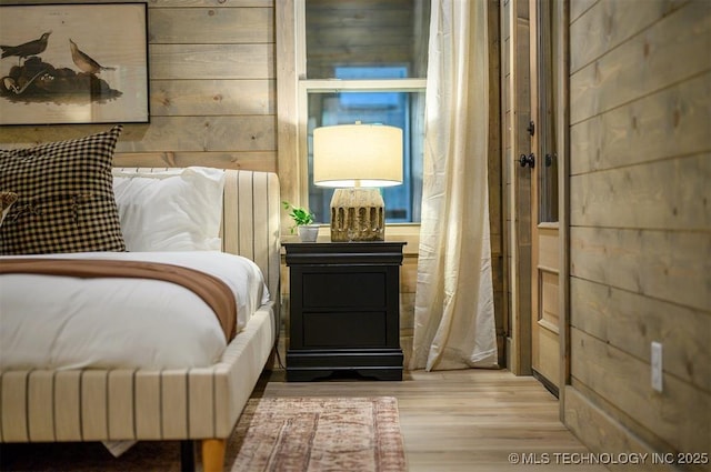 475 Bear Pine Trl, Broken Bow, OK 74728 - bedroom with wood finished floors and wood walls