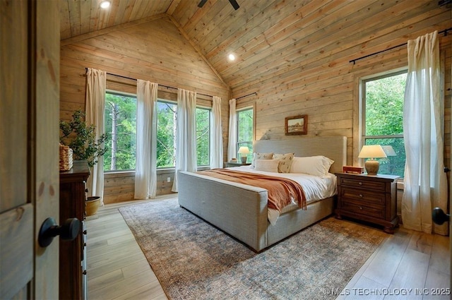 475 Bear Pine Trl, Broken Bow, OK 74728 - bedroom featuring multiple windows, wood walls, wooden ceiling, light wood-type flooring, and high vaulted ceiling