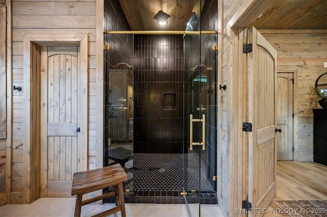 475 Bear Pine Trl, Broken Bow, OK 74728 - bathroom featuring wood walls, a shower stall, and wood finished floors