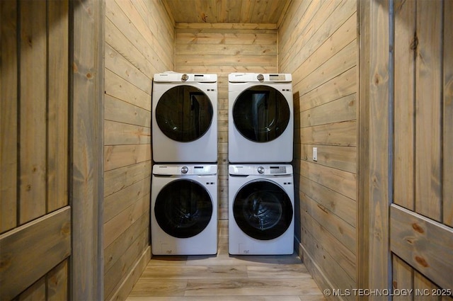 475 Bear Pine Trl, Broken Bow, OK 74728 - laundry area featuring estacked washer and dryer, wood walls, wooden ceiling, washer and dryer, and light wood-type flooring