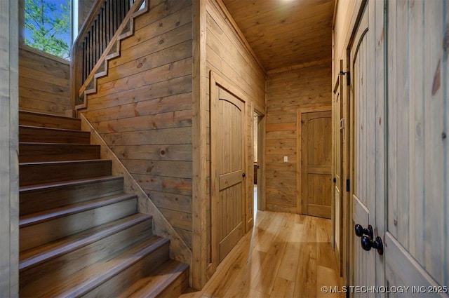 475 Bear Pine Trl, Broken Bow, OK 74728 - stairs featuring wooden walls, wood finished floors, and wooden ceiling