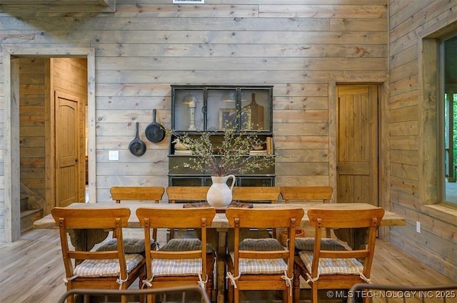 475 Bear Pine Trl, Broken Bow, OK 74728 - dining space with wooden walls and wood finished floors