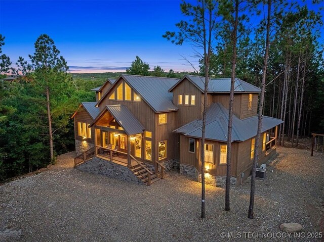 475 Bear Pine Trl, Broken Bow, OK 74728 - back of house at dusk with a metal roof, a porch, and crawl space