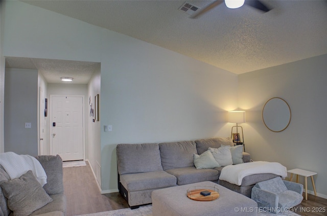 13866 S Nyssa Pl, Glenpool, OK 74033 - living room featuring a textured ceiling, wood finished floors, baseboards, and a ceiling fan