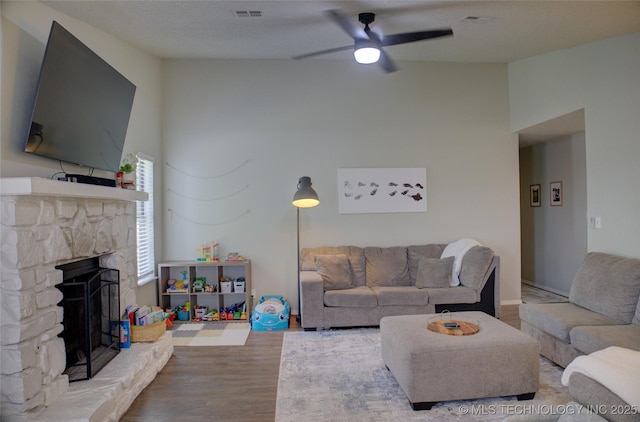 13866 S Nyssa Pl, Glenpool, OK 74033 - living area with ceiling fan, wood finished floors, and a fireplace