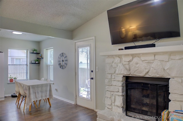 13866 S Nyssa Pl, Glenpool, OK 74033 - living area with wood finished floors, a fireplace, a textured ceiling, lofted ceiling, and baseboards