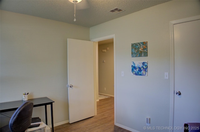 13866 S Nyssa Pl, Glenpool, OK 74033 - office area with wood finished floors, a textured ceiling, and baseboards