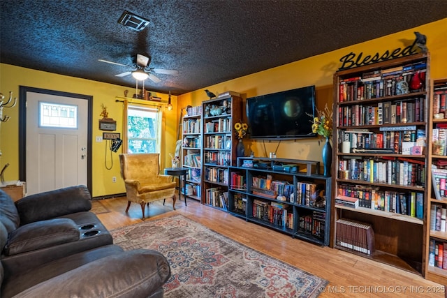 420 E Elm St, Skiatook, OK 74070 - living area featuring wood finished floors, ceiling fan, and a textured ceiling