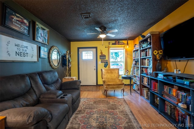 420 E Elm St, Skiatook, OK 74070 - living area featuring ceiling fan, a textured ceiling, and wood finished floors