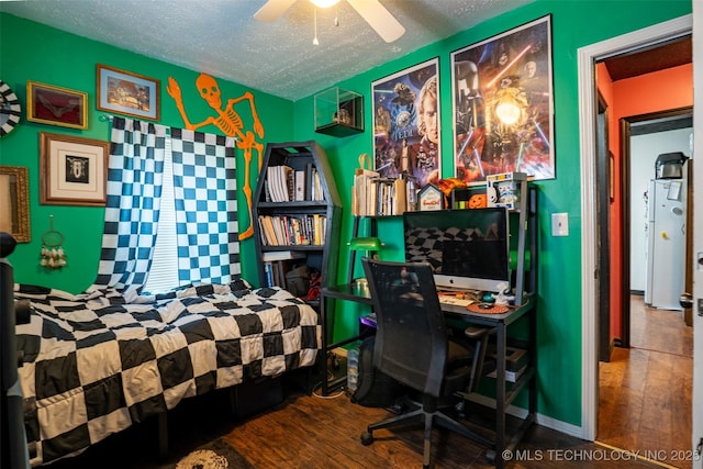 420 E Elm St, Skiatook, OK 74070 - bedroom with wood-type flooring, a textured ceiling, an office area, and freestanding refrigerator