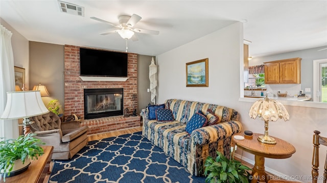 30955 S 4240th Rd, Inola, OK 74036 - living room featuring ceiling fan, wood finished floors, a fireplace, and baseboards