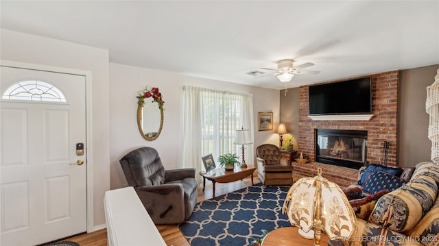 30955 S 4240th Rd, Inola, OK 74036 - living room with healthy amount of natural light, light wood-type flooring, a brick fireplace, and a ceiling fan