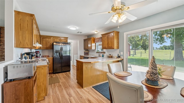 30955 S 4240th Rd, Inola, OK 74036 - kitchen featuring stainless steel refrigerator with ice dispenser, light wood-style floors, a peninsula, and light countertops