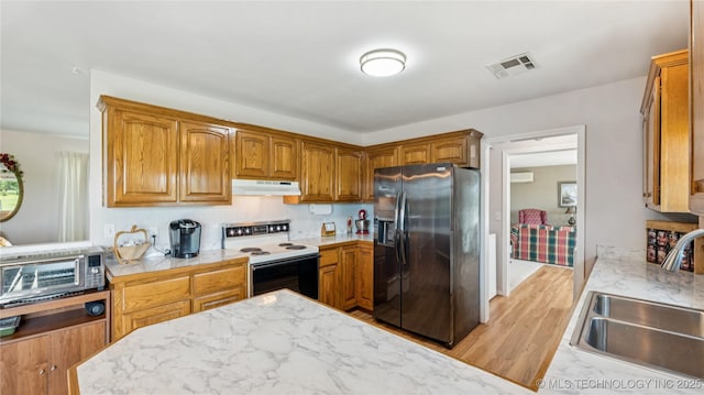 30955 S 4240th Rd, Inola, OK 74036 - kitchen featuring refrigerator with ice dispenser, white electric stove, a sink, under cabinet range hood, and light wood-style flooring