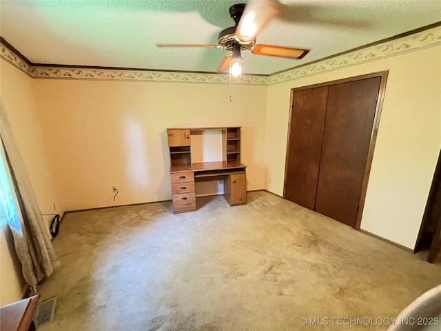 116800 S 4300th Rd, Porum, OK 74455 - unfurnished bedroom with light colored carpet, ceiling fan, a textured ceiling, a closet, and baseboards