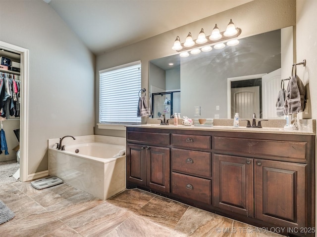 18210 E 49th St, Tulsa, OK 74134 - full bathroom featuring a garden tub, double vanity, a shower stall, and lofted ceiling