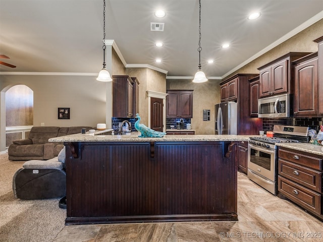 18210 E 49th St, Tulsa, OK 74134 - kitchen featuring stainless steel appliances, ornamental molding, a breakfast bar area, dark brown cabinetry, and open floor plan
