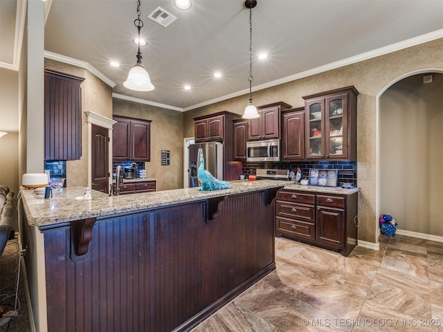 18210 E 49th St, Tulsa, OK 74134 - kitchen with appliances with stainless steel finishes, ornamental molding, a kitchen breakfast bar, a peninsula, and dark brown cabinetry