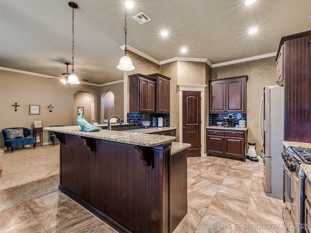 18210 E 49th St, Tulsa, OK 74134 - kitchen with appliances with stainless steel finishes, a kitchen breakfast bar, a peninsula, dark brown cabinetry, and a ceiling fan