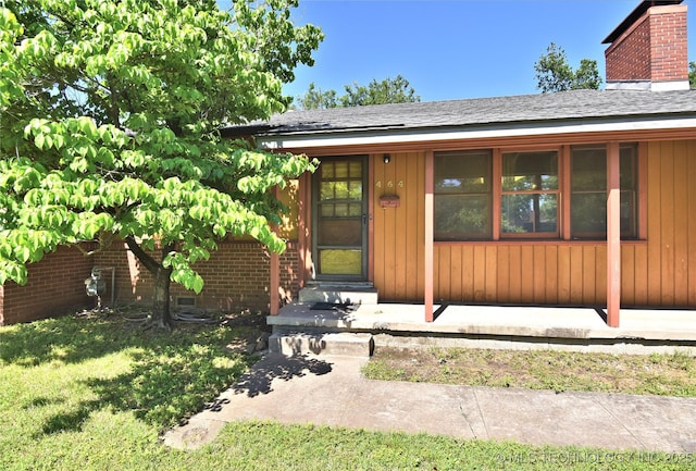 464 S Allegheny Ave, Tulsa, OK 74112 - property entrance featuring a chimney and roof with shingles