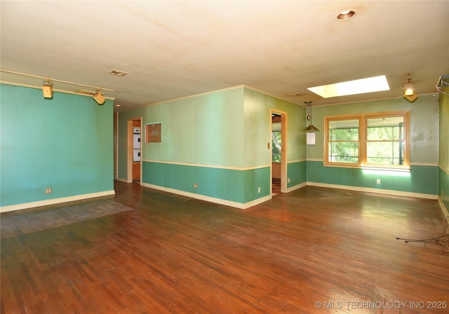 464 S Allegheny Ave, Tulsa, OK 74112 - unfurnished room with a skylight, wood finished floors, baseboards, and crown molding