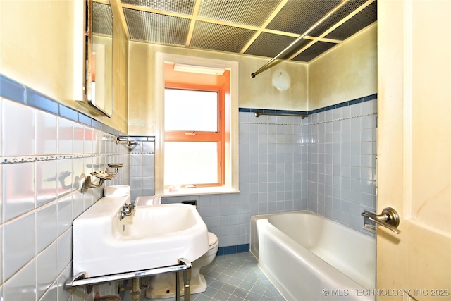 464 S Allegheny Ave, Tulsa, OK 74112 - bathroom with tile walls, toilet, tile patterned flooring, and bathtub / shower combination
