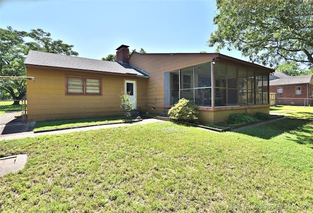 464 S Allegheny Ave, Tulsa, OK 74112 - view of front of home with a sunroom, a front yard, and a chimney