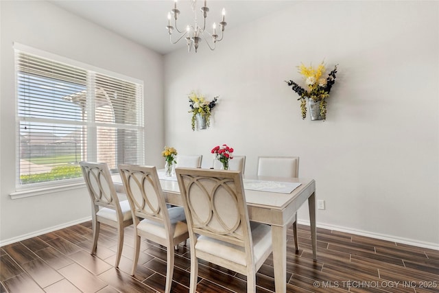 2023 E 133rd St S, Bixby, OK 74008 - dining area with baseboards, a chandelier, and wood finish floors
