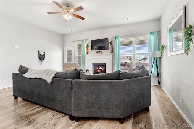 2023 E 133rd St S, Bixby, OK 74008 - living room featuring ceiling fan, a brick fireplace, wood finished floors, and baseboards