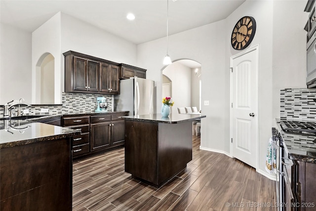 2023 E 133rd St S, Bixby, OK 74008 - kitchen featuring appliances with stainless steel finishes, a sink, dark brown cabinetry, tasteful backsplash, and recessed lighting