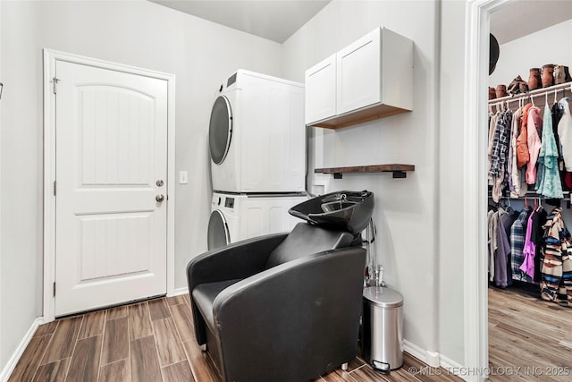2023 E 133rd St S, Bixby, OK 74008 - laundry room with stacked washer and clothes dryer, cabinet space, wood finished floors, and baseboards