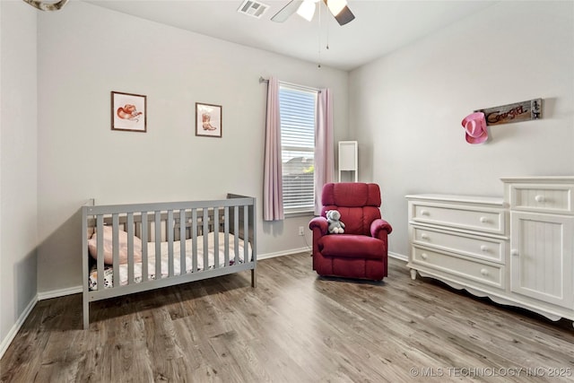 2023 E 133rd St S, Bixby, OK 74008 - bedroom featuring wood finished floors, a nursery area, baseboards, and ceiling fan