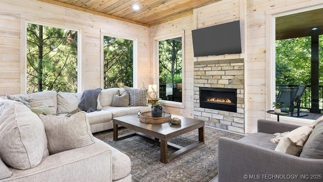 62 Hickory Canyon Trl, Broken Bow, OK 74728 - living room with wooden ceiling, wooden walls, a stone fireplace, healthy amount of natural light, and recessed lighting