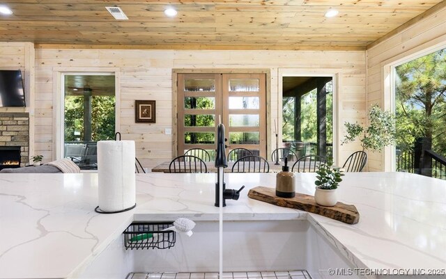 62 Hickory Canyon Trl, Broken Bow, OK 74728 - dining room featuring wood ceiling, recessed lighting, wooden walls, french doors, and an outdoor stone fireplace