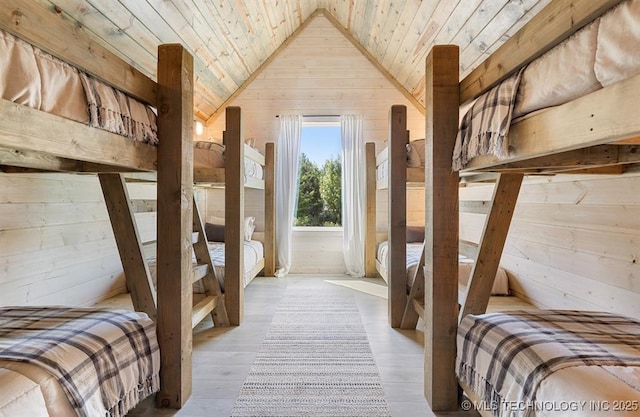 62 Hickory Canyon Trl, Broken Bow, OK 74728 - bedroom featuring wooden walls, wood ceiling, vaulted ceiling, and wood finished floors