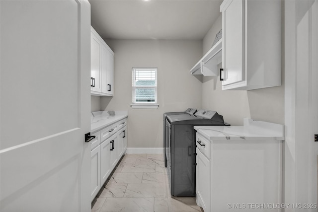 5769 S 256th E Ave, Broken Arrow, OK 74014 - laundry area featuring light marble finish floors, cabinet space, independent washer and dryer, and baseboards