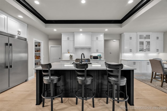 5769 S 256th E Ave, Broken Arrow, OK 74014 - kitchen with stainless steel built in fridge, a tray ceiling, a spacious island, backsplash, and recessed lighting
