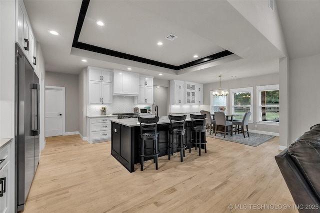 5769 S 256th E Ave, Broken Arrow, OK 74014 - kitchen with a tray ceiling, high quality fridge, baseboards, light wood-type flooring, and a chandelier