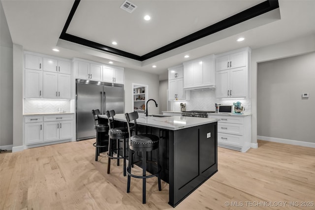 5769 S 256th E Ave, Broken Arrow, OK 74014 - kitchen featuring high quality fridge, a sink, a raised ceiling, baseboards, and a kitchen breakfast bar