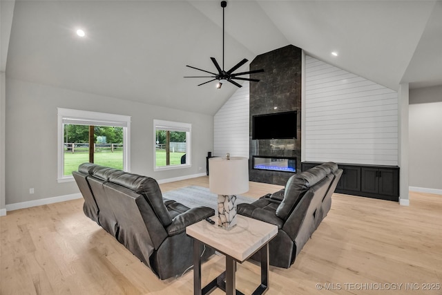 5769 S 256th E Ave, Broken Arrow, OK 74014 - living room with baseboards, ceiling fan, high vaulted ceiling, light wood-style flooring, and a fireplace