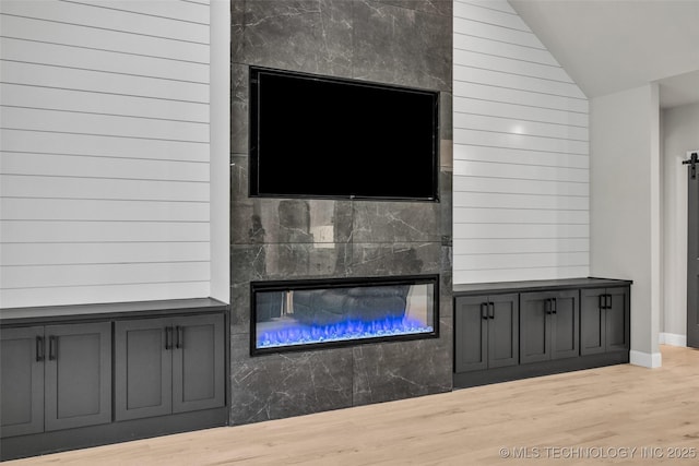 5769 S 256th E Ave, Broken Arrow, OK 74014 - detailed view of wood finished floors, a glass covered fireplace, and baseboards