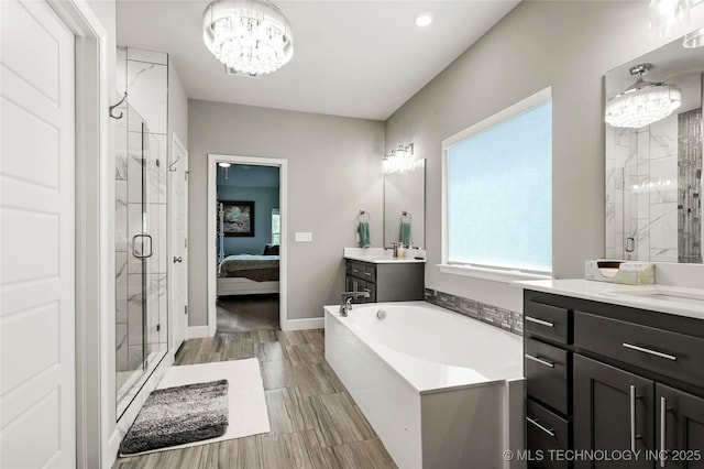8617 E Hartford St, Broken Arrow, OK 74014 - bathroom with a chandelier, a shower stall, two vanities, a garden tub, and ensuite bathroom