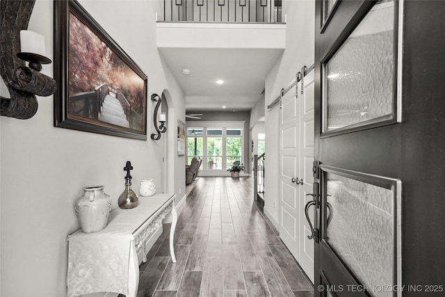 8617 E Hartford St, Broken Arrow, OK 74014 - foyer featuring a barn door, recessed lighting, and wood finished floors