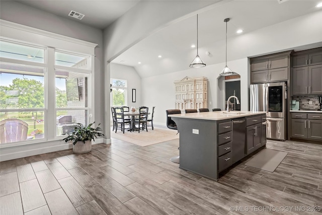 8617 E Hartford St, Broken Arrow, OK 74014 - kitchen featuring stainless steel appliances, a sink, light countertops, gray cabinets, and lofted ceiling
