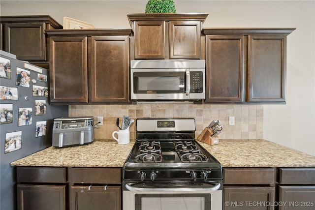 2704 W Imperial St, Broken Arrow, OK 74011 - kitchen featuring appliances with stainless steel finishes, dark brown cabinetry, and backsplash