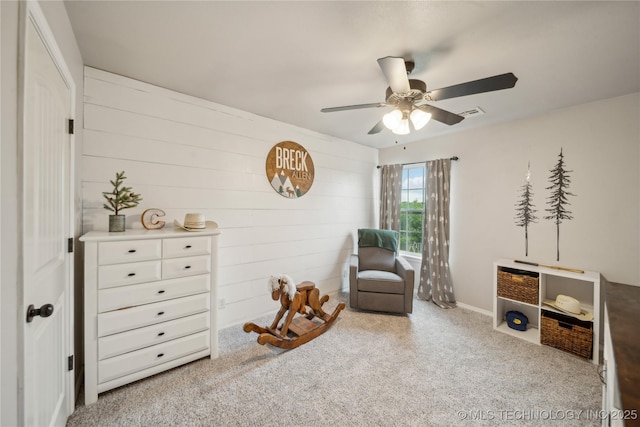 2704 W Imperial St, Broken Arrow, OK 74011 - sitting room featuring ceiling fan, carpet flooring, and wooden walls